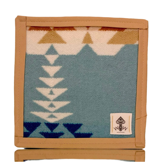 A rectangular Pendleton mat with a geometric pattern in blue and beige, featuring the Wook Wear logo.