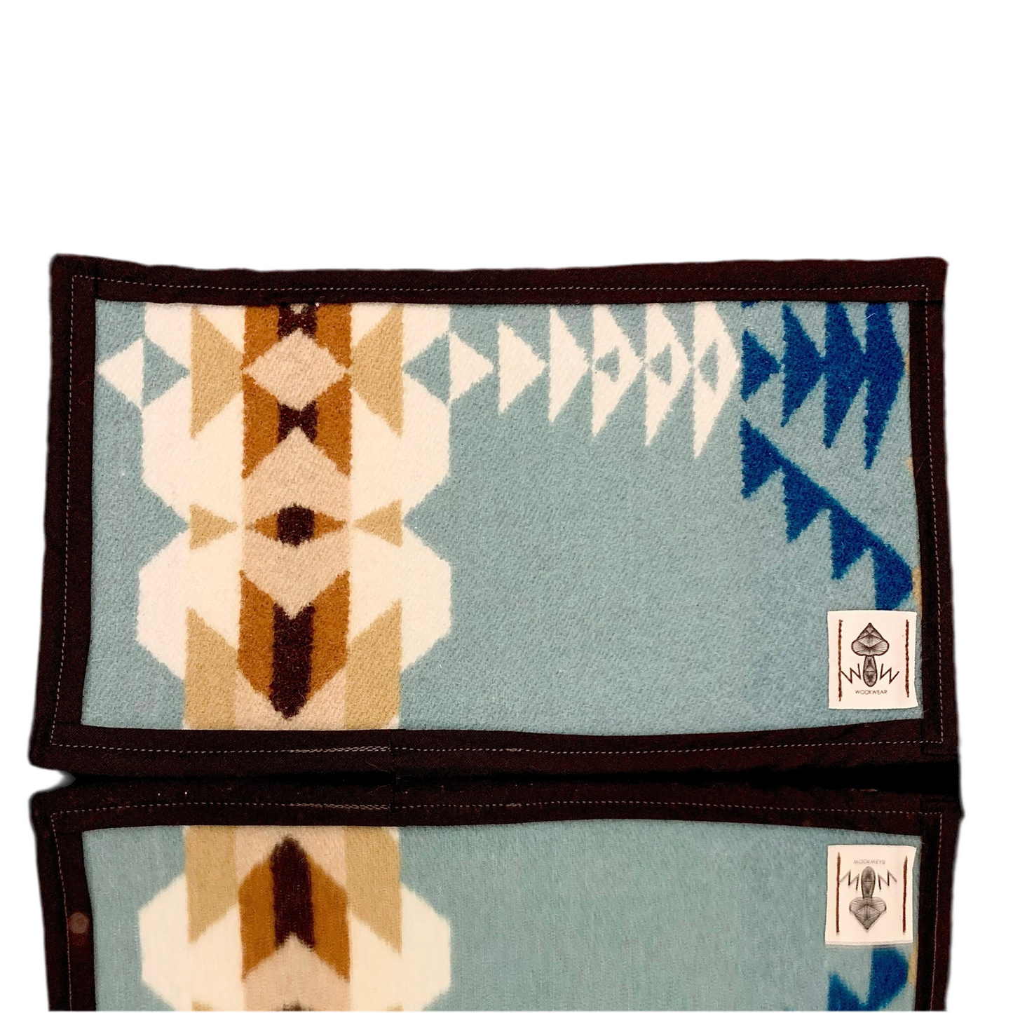 A rectangular Pendleton mat featuring a geometric pattern with blue, beige, and brown colors, with the Wook Wear logo on the bottom right corner.