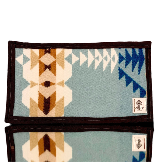 A rectangular Pendleton mat featuring a geometric pattern with blue, beige, and brown colors, with the Wook Wear logo on the bottom right corner.