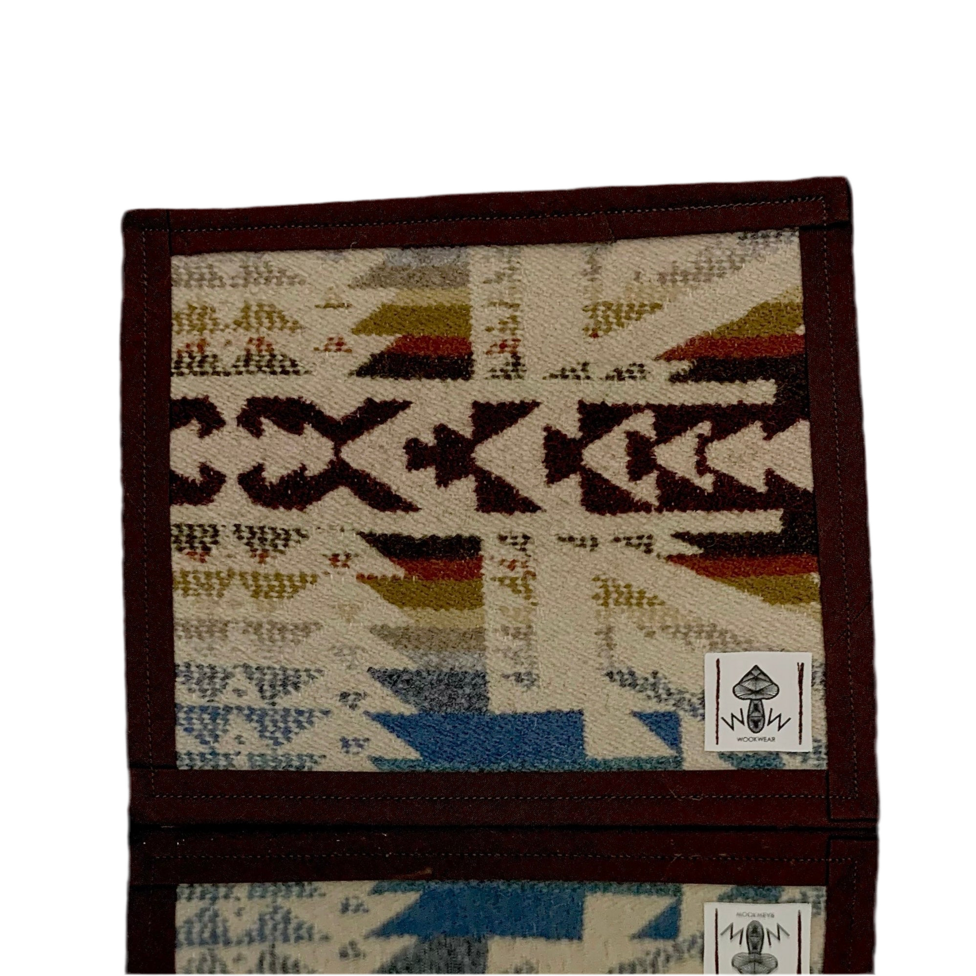 A rectangular Pendleton mat featuring a geometric pattern with upcycled fabric.