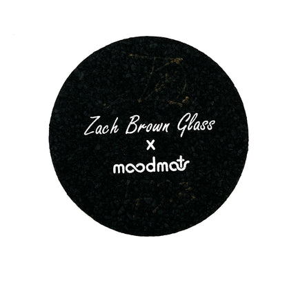 Black circular mat with 'Zach Brown Glass x moodmat' text on a white background.