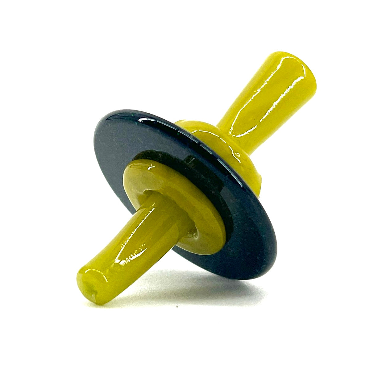 Yellow and black glass stopper on a white background.
