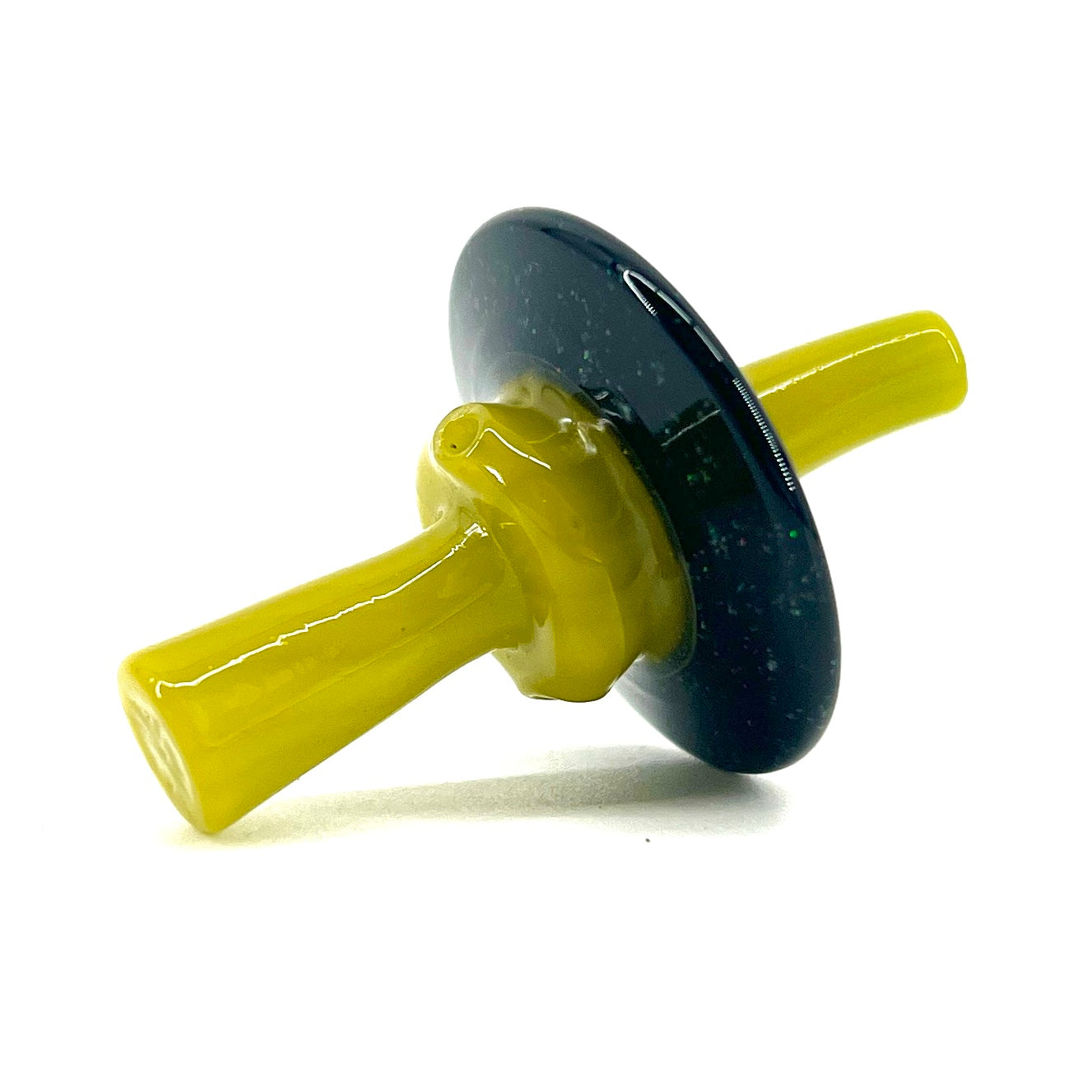 Glass cap with yellow and black design on a white background