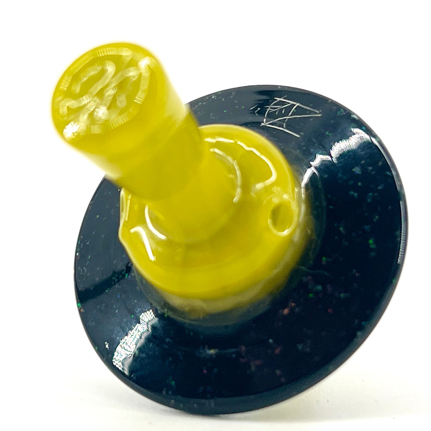 Yellow cap with a dark speckled brim.